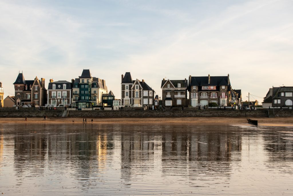 line of buildings and body of water during day